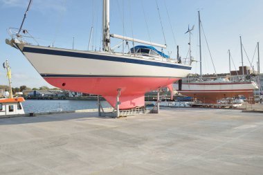 45 ft cruising sailboat standing on land in a yacht marina. Transportation, nautical vessel, repair and service, sailing, sport, recreation. tourism, leisure activity concepts