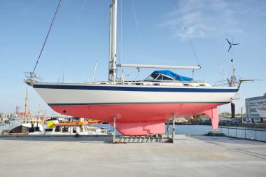 45 ft cruising sailboat standing on land in a yacht marina. Transportation, nautical vessel, repair and service, sailing, sport, recreation. tourism, leisure activity concepts
