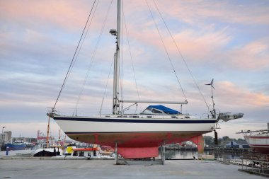 45 ft cruising sailboat standing on land in a yacht marina. Transportation, nautical vessel, repair and service, sailing, sport, recreation. tourism, leisure activity concepts