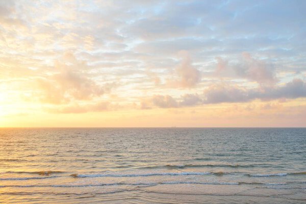 Panoramic view from the Baltic sea shore at sunset. Dramatic cloudscape, glowing clouds, golden sunlight after the storm. Nature, environment, climate change, fickle weather