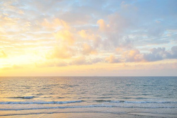 Panoramic view from the Baltic sea shore at sunset. Dramatic cloudscape, glowing clouds, golden sunlight after the storm. Nature, environment, climate change, fickle weather