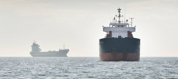 General cargo ship (88 meters length) sailing in the Baltic sea. Freight transportation, logistics, global communications, economy, industry, supply, environment