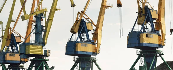 Riga, Letonya 'daki modern kömür terminali. Vinçler yakın plan. Baltık Denizi. Nakliye, lojistik, küresel iletişim, ekonomi, iş, endüstri, tedarik, özel ekipman. Şehir manzarası