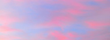 Açık mavi gökyüzü. Pembe parlayan, altın sirrus ve kümülüs bulutları fırtına üstüne, yumuşak güneş ışığı. Gün batımı bulutları. Meteoroloji, gece yarısı güneşi, cennet, huzur, grafik kaynakları, resimli panoramik manzara