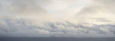 Ornamental clouds. Dramatic sky after the storm. Cloudscape. Soft sunlight. Panoramic image, texture, background, graphic resources, design, copy space. Meteorology, heaven, hope, peace concept