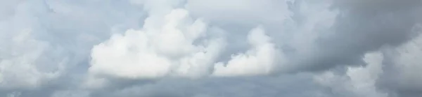 Ornamental clouds. Dramatic sky. Epic storm cloudscape. Soft sunlight. Panoramic image, texture, background, graphic resources, design, copy space. Meteorology, heaven, hope, peace concept