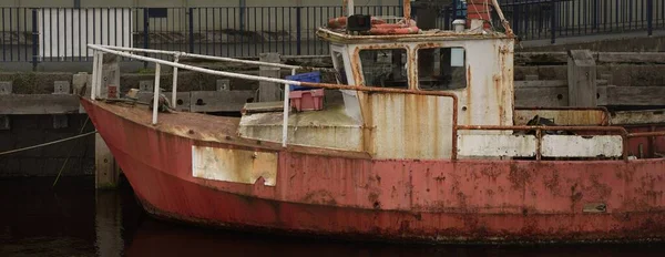 Old fishing boat anchored in harbor. Rothesay, Scotland, UK. Nautical vessel, transportation, traditional craft, industry