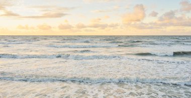 Deniz dalgaları ve sıçrama dokusu. Renkli gökyüzü suya yansıyor. Idyllic deniz manzarası. Kavramsal görüntü, uzun pozlama. Resimli bir manzara var. Arkaplan, duvar kağıdı, doğal desen, grafik kaynakları