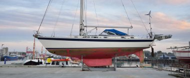 45 ft cruising sailboat standing on land in a yacht marina. Transportation, nautical vessel, repair and service, sailing, sport, recreation. tourism, leisure activity concepts