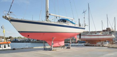 45 ft cruising sailboat standing on land in a yacht marina. Transportation, nautical vessel, repair and service, sailing, sport, recreation. tourism, leisure activity concepts