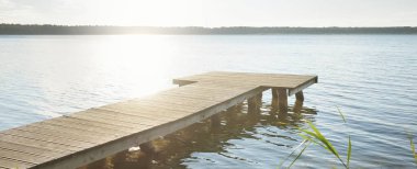 Orman nehri (göl) güneşli bir günde. Ahşap iskele. Clea gökyüzü, kristal berrak suda yansıyor. Idyllic manzara, kırsal manzara. Doğa, ekoloji, eko-turizm, yürüyüş, ekoloji beldesi, yerel turizm