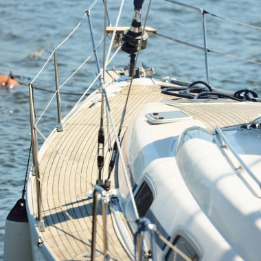 Limandaki bir rıhtıma demirlenmiş modern bir yat. Tahta meşe güvertesi, direği ve yelkenleri yukarıdan görüyor. Akdeniz 'de. Kiralık, gezici, eğlence, eğlence, eğlence, spor, yelkenli yarışı için özel bir gemi.