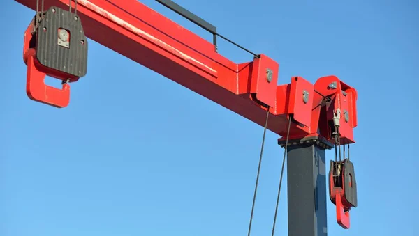 Close-up of a modern lifting crane in a yacht marina. Transportation, port service, repair, special equipment, technology