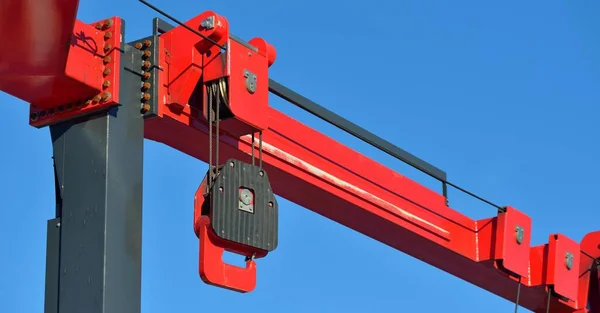 Close-up of a modern lifting crane in a yacht marina. Transportation, port service, repair, special equipment, technology