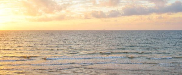 Panoramic view from the Baltic sea shore at sunset. Dramatic cloudscape, glowing clouds, golden sunlight after the storm. Nature, environment, climate change, fickle weather