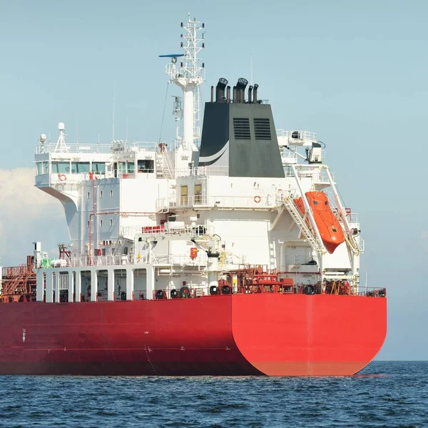 Large red cargo ship (oil chemical tanker, 184  meters length) sailing in the Baltic sea. Freight transportation, logistics, global communications, economy, industry, supply, environment
