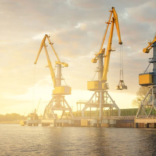 Modern cargo port terminal in Riga, Latvia. Cranes close-up. Dramatic sky. Baltic sea. Freight transportation, logistics, global communications, economy, business, industry, supply, special equipment