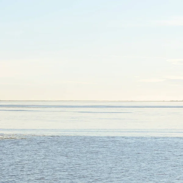 Gün batımında mavi orman gölü (nehir) panoramik hava manzarası. Yumuşak güneş ışığı, berrak gökyüzü, suya yansıyan yansımalar. Baharın başında. İdealist pastoral manzara. Doğa, çevre, ekoloji, eko-turizm
