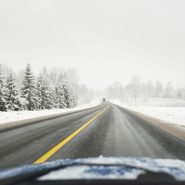 雪に覆われた森林やフィールドを介して空の高速道路 アスファルト道路 アメリカだ クリスマス休暇 遠隔地 冬のタイヤ 危険な運転の概念 — ストック写真