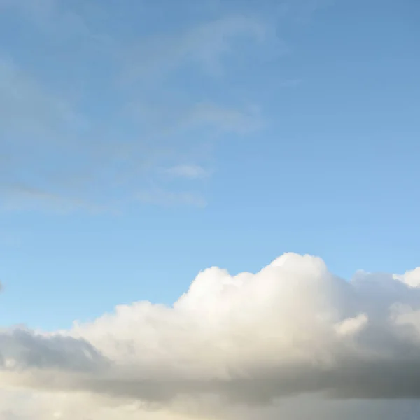 Ornamental clouds. Dramatic sky. Epic storm cloudscape. Soft sunlight. Panoramic image, texture, background, graphic resources, design, copy space. Meteorology, heaven, hope, peace concept