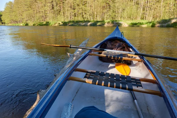 Canoe riding on Irbe river. Kurzeme, Latvia. Forest. mighty trees, reflections in water. Nature, ecology, eco tourism, hiking, leisure activity, boating, rowing, sport, healthy lifestyle, wanderlust