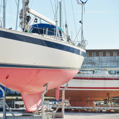 45 ft cruising sailboat standing on land in a yacht marina. Transportation, nautical vessel, repair and service, sailing, sport, recreation. tourism, leisure activity concepts