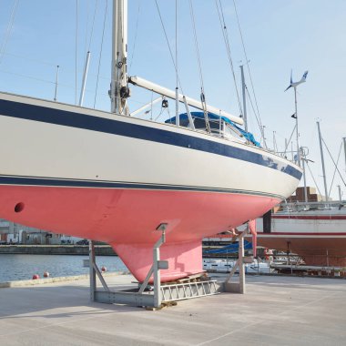 45 ft cruising sailboat standing on land in a yacht marina. Transportation, nautical vessel, repair and service, sailing, sport, recreation. tourism, leisure activity concepts
