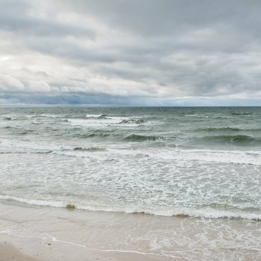 Fırtına sırasında Baltık Denizi. Dramatik gökyüzü, karanlık, parlak bulutlar. Dalgalar, su sıçramaları. Idyllic deniz manzarası. İklim değişikliği, doğa, kararsız hava, ekoloji