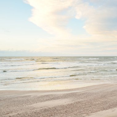 Gün batımında Baltık kıyısı. Açık günbatımı gökyüzü, parlayan bulutlar. Idyllic manzara. Doğa, tatiller, eğlence. Çevre turizmi. Panoramik görünüm