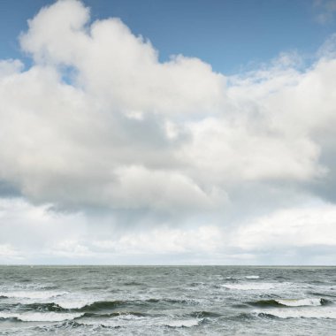 Fırtınadan sonra dramatik günbatımı bulutları altında Baltık Denizi. Dalgalar, su sıçratma. Destansı deniz manzarası. Kasırga, fırtına, sert hava, meteoroloji, ekoloji, iklim değişikliği, doğal olaylar