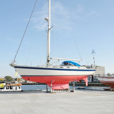 45 ft cruising sailboat standing on land in a yacht marina. Transportation, nautical vessel, repair and service, sailing, sport, recreation. tourism, leisure activity concepts