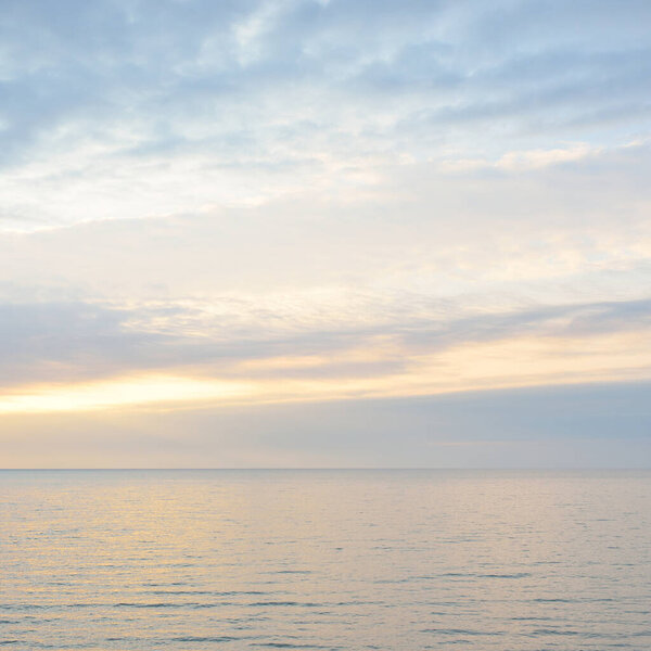 Panoramic aerial view from the Baltic sea shore at sunset. Dramatic cloudscape, glowing clouds, golden sunlight after the storm. Nature, environment, climate change, fickle weather