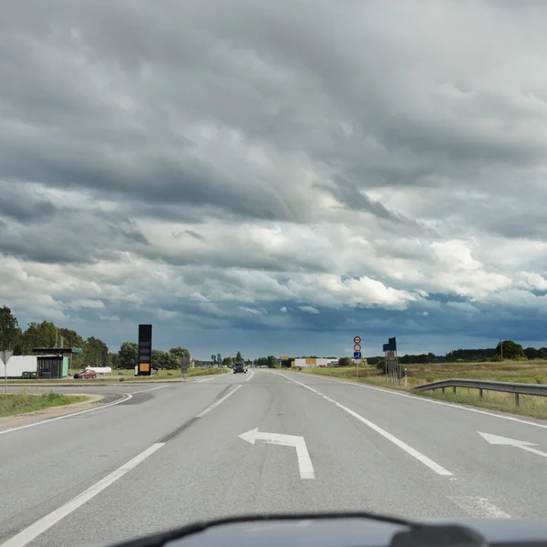 Country highway (asphalt road) through the fields and forest. View from ...