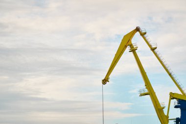 Letonya, Ventspils 'deki kargo terminali. Vinçler yakın plan. Baltık Denizi. Dramatik gün batımı gökyüzü. Yük taşımacılığı, lojistik, küresel iletişim, işletme, sanayi, arz, özel ekipman