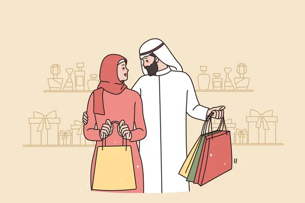 Rico pareja árabe con bolsas de compras en el centro comercial — Vector de stock