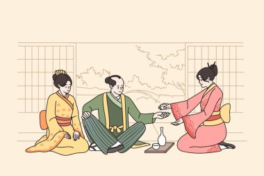 Japon kostümlü insanlar çay seremonisi yaparlar. 
