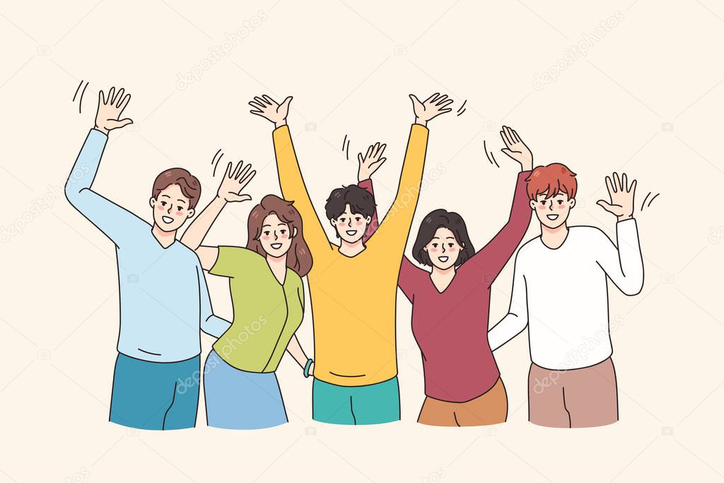 Happy young people raise hands have fun together 