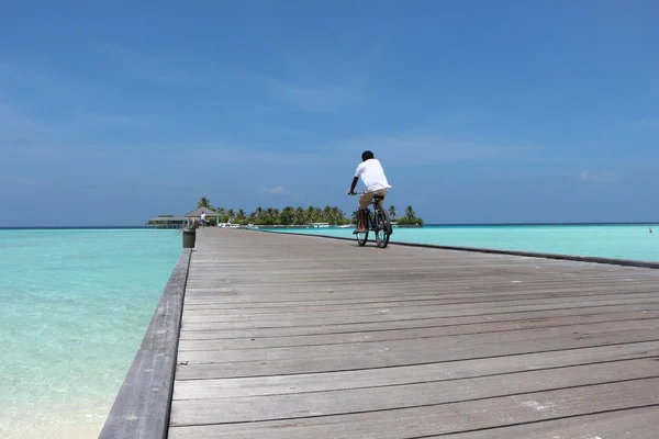 Man and bicycle on bridge. Sun Island — Stock Photo, Image