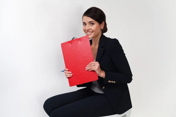 Beautiful business girl in black suit smiling with red portfolio — Stock Photo, Image