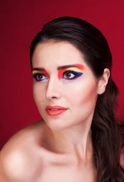 Portrait of a beautiful girl with colorful eyemakeup — Stock Photo, Image