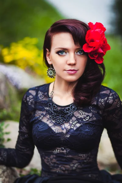 Beautiful girl with red flower — Stock Photo, Image