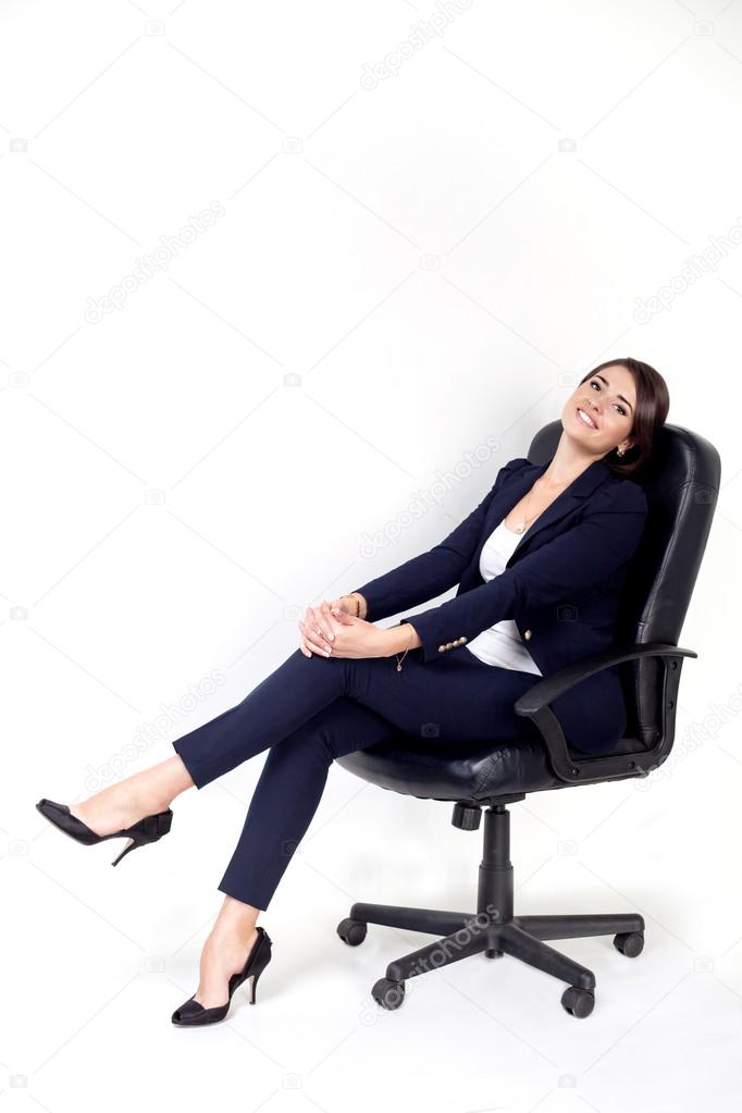 Happy successful business woman in office chair on white background