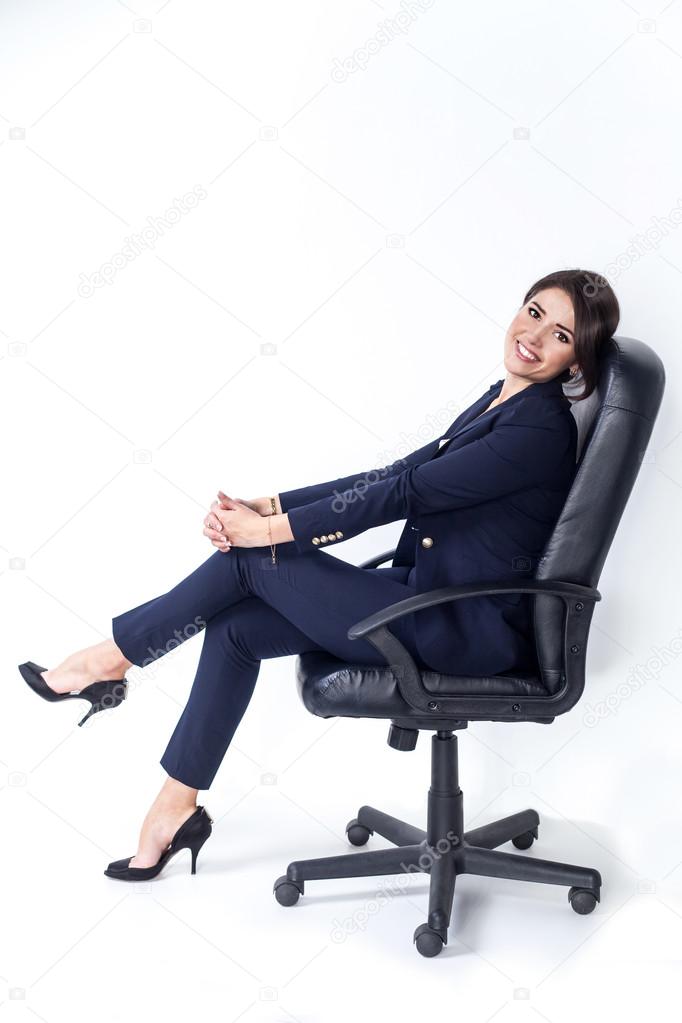 Happy successful business woman in office chair on white background