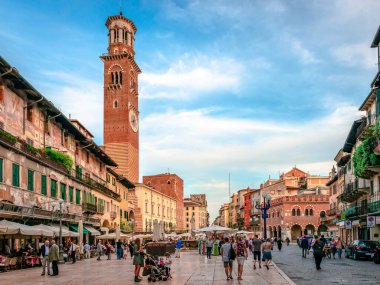 Verona, Italy - May 24 2018: View of Piazza delle Erbe (Market's square), with Torre dei Lamberti, a medieval 84 m high tower, in the historic old centre of the city.