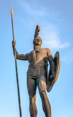 The statue of Achilles in full hoplite uniform, sanding as guardian of the palace in the gardens of Achilleion, in Gastouri, Corfu Island, Greece. clipart