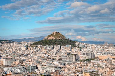 Athens, Greece - March 6 2022: Panorama of the Athens' skyline with the Lycabettus Mount. Photo taken from the Acropolis hill.