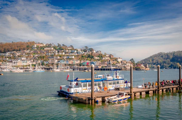 Dartmouth, UK - April 21 2014: The passengers are ready to embark on the ferry, at the North Embankment terminal. Kingswear, a village located on the east bank of river Dart, is in the background.