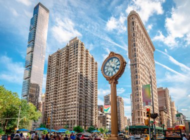 New York City, NY, USA - July 16 2014: View of One Madison building, Flatiron Building and the cast-iron sidewalk clock outside the Toys Center in Madison Square, Manhattan.