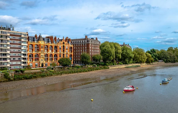 Victorian mansion blocks and art deco style architecture next to modern buildings, facing the river Thames in Fulham, London, England