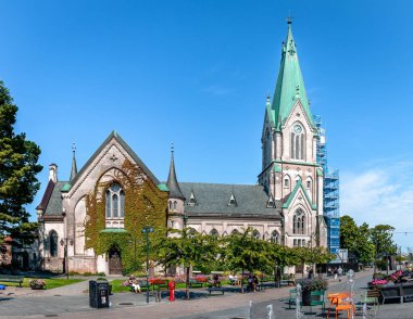 Kristiansand, Norway - August 15 2022: Kristiansand Cathedral is a Neo-Gothic church built of brick and cement, completed in 1885 clipart